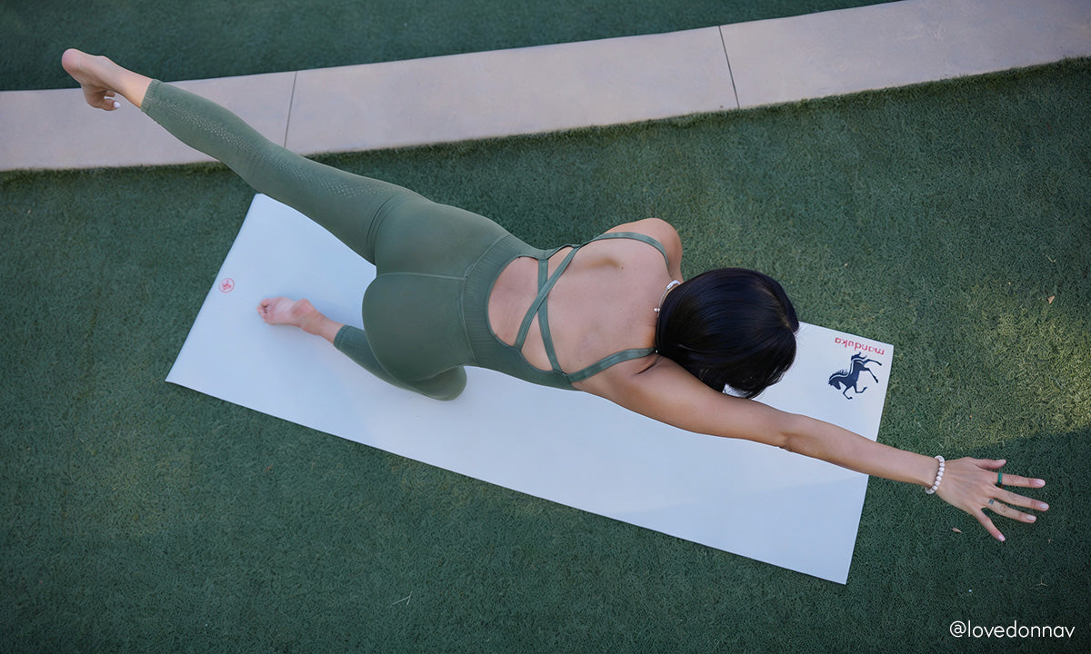 Yoga practitioner in bird dog pose on the Manduka PROlite Fire Horse yoga mat