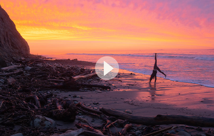Linda somersaulting at the beach during sunset