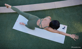 Yoga practitioner in bird dog pose on the Manduka PROlite Fire Horse yoga mat