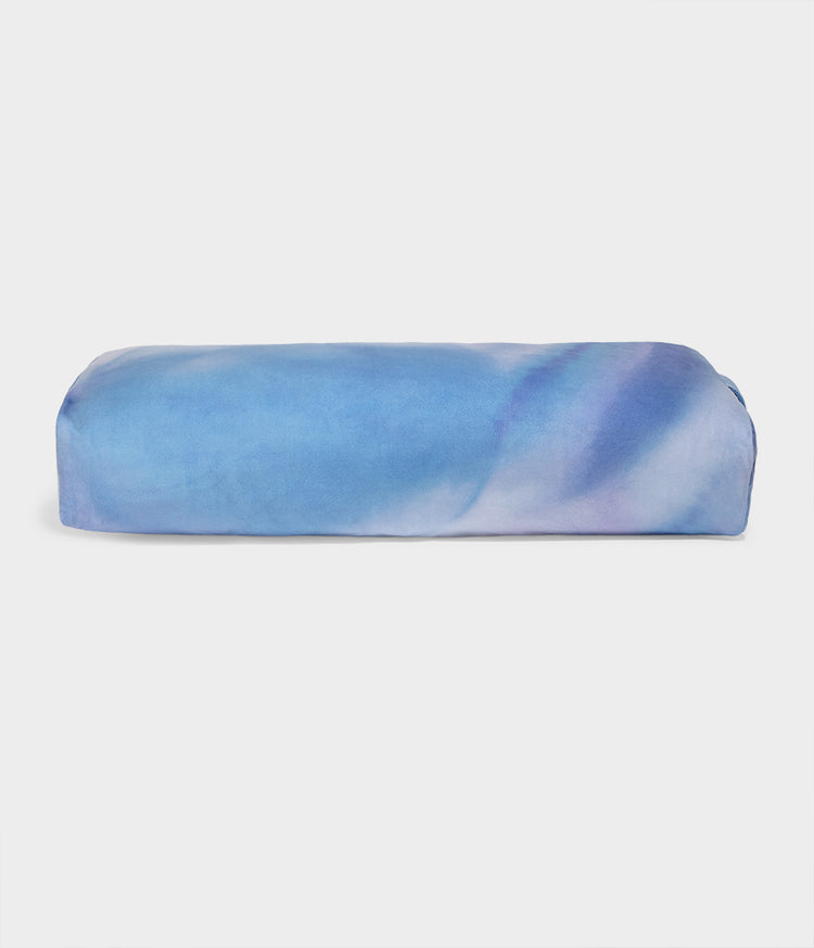 Manduka blue and purple rectangular yoga bolster with a firm structured shape for stable support during restorative yoga and meditation